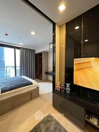 Modern bedroom with sleek design, large window, and built-in storage in urban apartment.