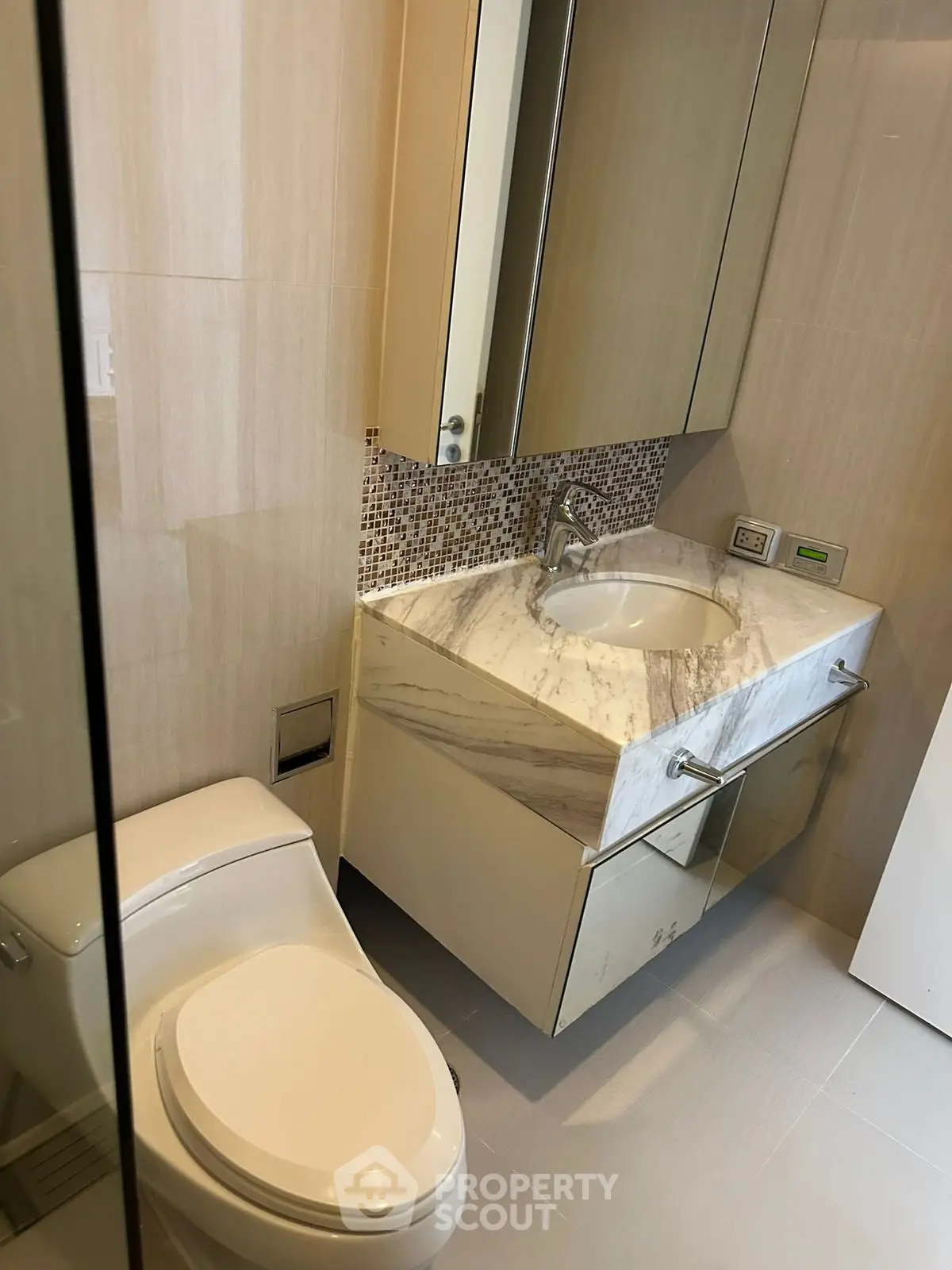 Modern bathroom with elegant marble sink and contemporary fixtures.
