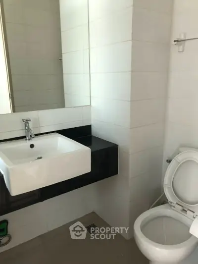 Modern bathroom with sleek sink and toilet in minimalist design