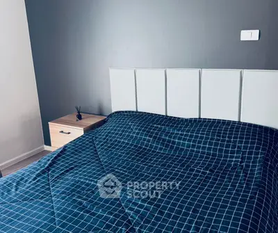 Modern bedroom with stylish headboard and checkered bedding