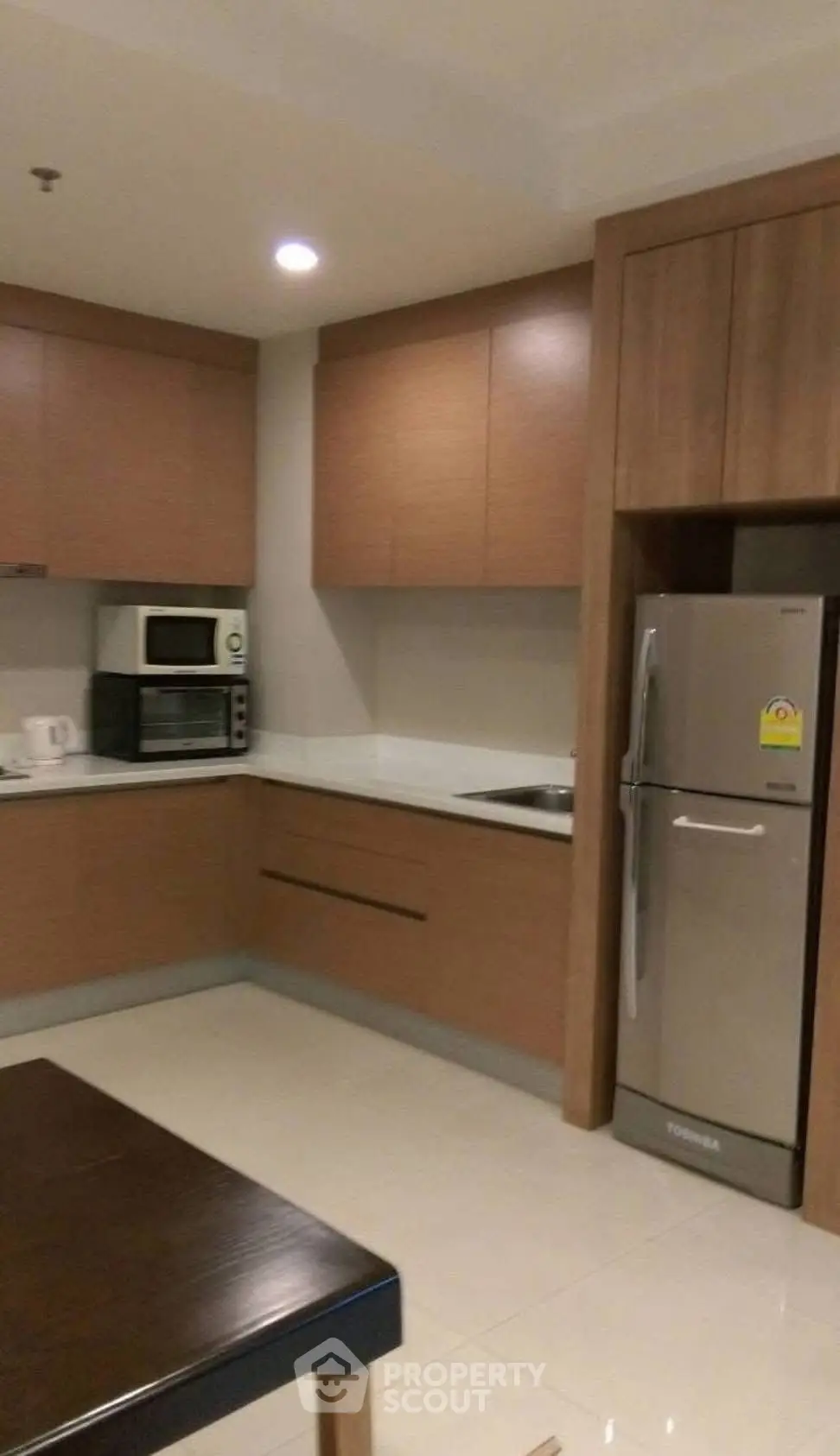 Modern kitchen with sleek wooden cabinets and stainless steel appliances