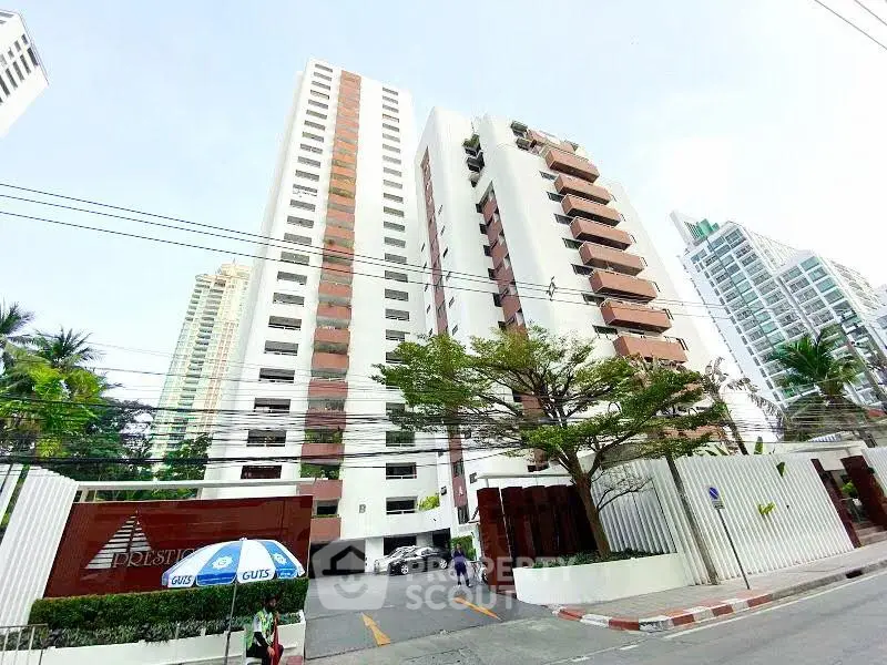 Stunning high-rise building exterior with modern architecture and lush surroundings in prime urban location.