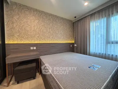 Modern bedroom with stylish wallpaper and large window for natural light