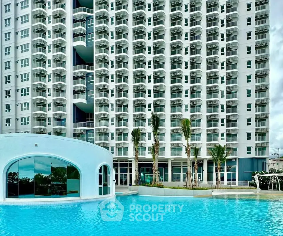 Luxurious high-rise building with stunning pool and modern architecture.