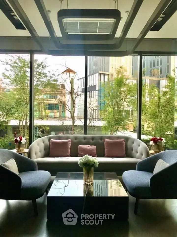 Luxurious modern living room with large windows and elegant furniture overlooking cityscape.