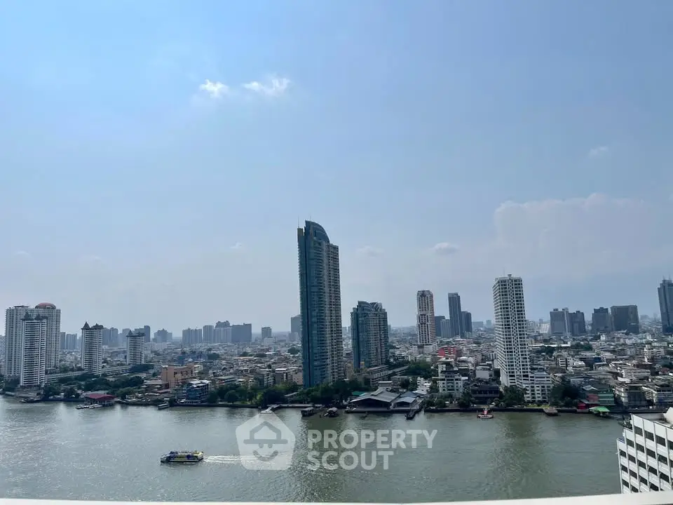 Stunning cityscape view from a high-rise building overlooking a river, perfect for urban living enthusiasts.