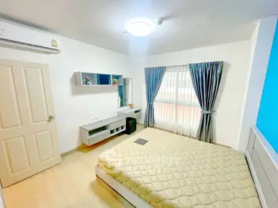 Bright and modern bedroom with stylish decor and ample natural light.