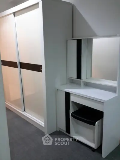 Modern bedroom with sleek wardrobe and stylish vanity set