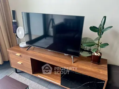 Modern living room with sleek TV stand and stylish decor, perfect for cozy entertainment nights.
