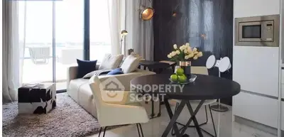 Modern living room with stylish decor and open balcony view