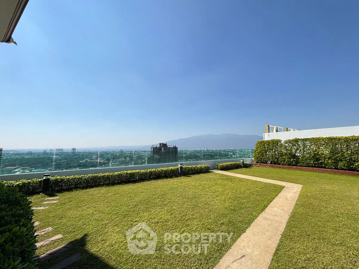 Stunning rooftop garden with panoramic city and mountain views.