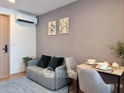 Modern living room with cozy sofa and dining area in stylish apartment.