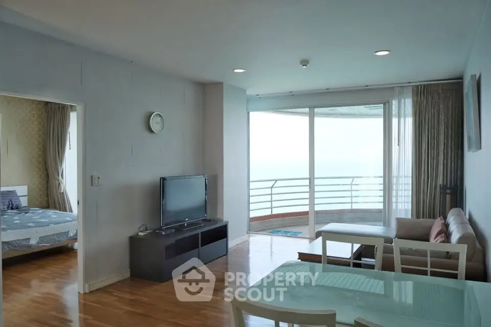 Spacious living room with ocean view balcony in modern apartment