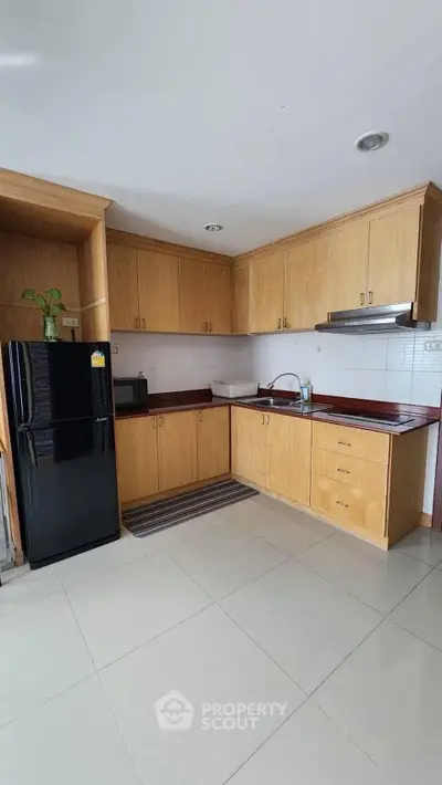 Spacious kitchen with wooden cabinets and modern appliances
