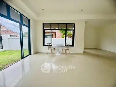 Spacious modern living room with large windows and garden view