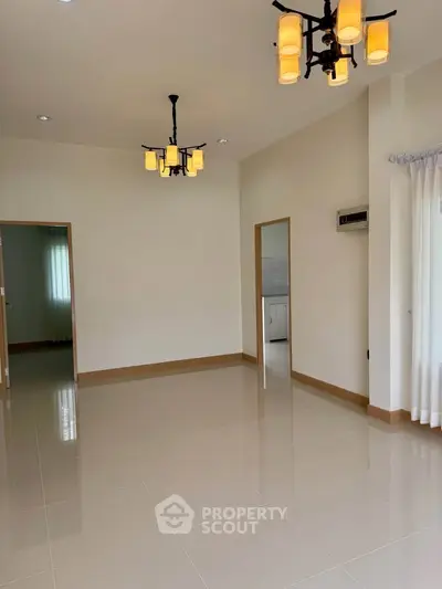 Spacious and bright living room with modern lighting and tiled flooring