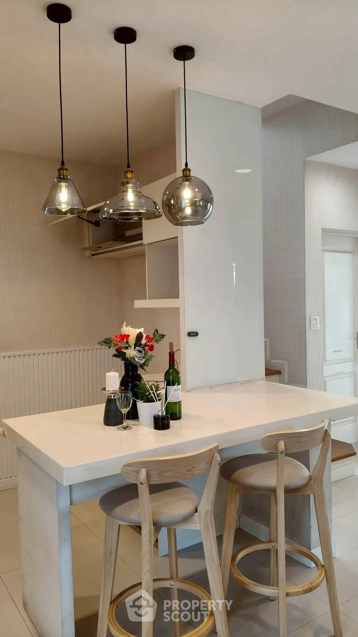 Modern kitchen with stylish pendant lights and breakfast bar seating