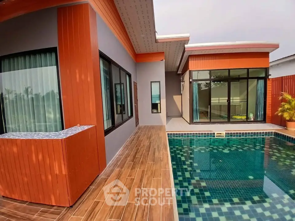 Modern home with sleek poolside design and large windows for natural light.