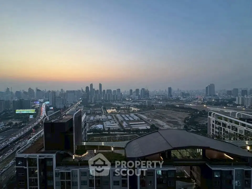 Stunning cityscape view from high-rise building at sunset, showcasing urban skyline and vibrant city life.