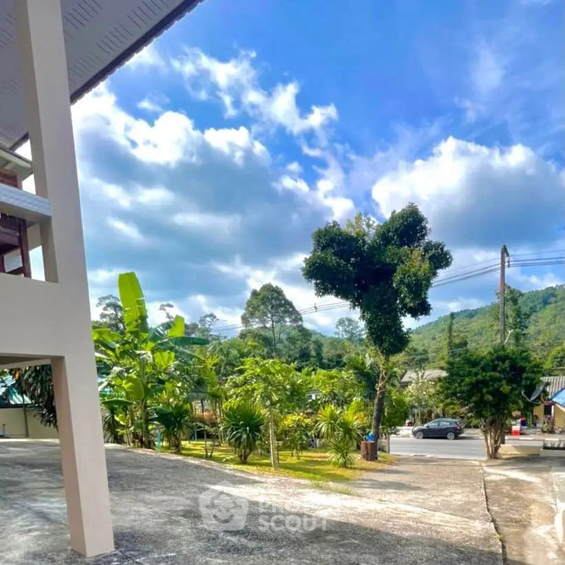 Scenic view from property with lush greenery and clear blue sky, ideal for nature lovers.