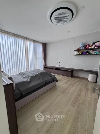 Spacious modern bedroom with large windows and stylish decor