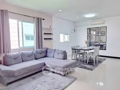 Spacious modern living room with elegant dining area and large windows