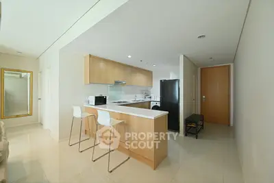 Modern kitchen with sleek design and open layout, featuring a breakfast bar and contemporary appliances.