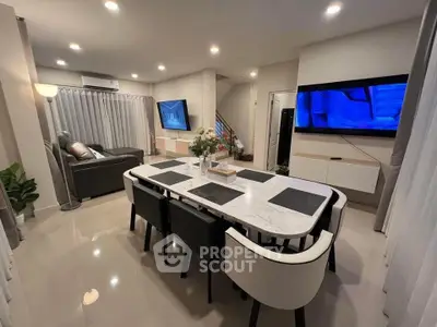 Modern open-plan living and dining area with sleek furniture and ambient lighting.