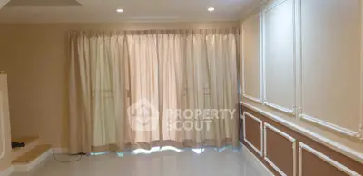 Elegant living room with soft lighting and floor-to-ceiling curtains