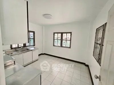 Spacious kitchen with ample natural light and tiled flooring