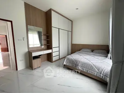 Spacious modern bedroom with sleek design and ample storage space.