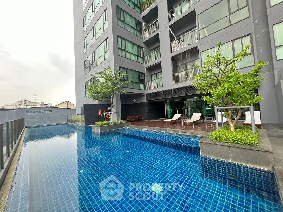 Modern apartment building with luxurious pool and lounge area