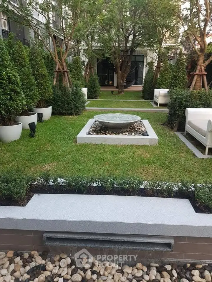 Elegant garden with modern landscaping and water feature in luxury property