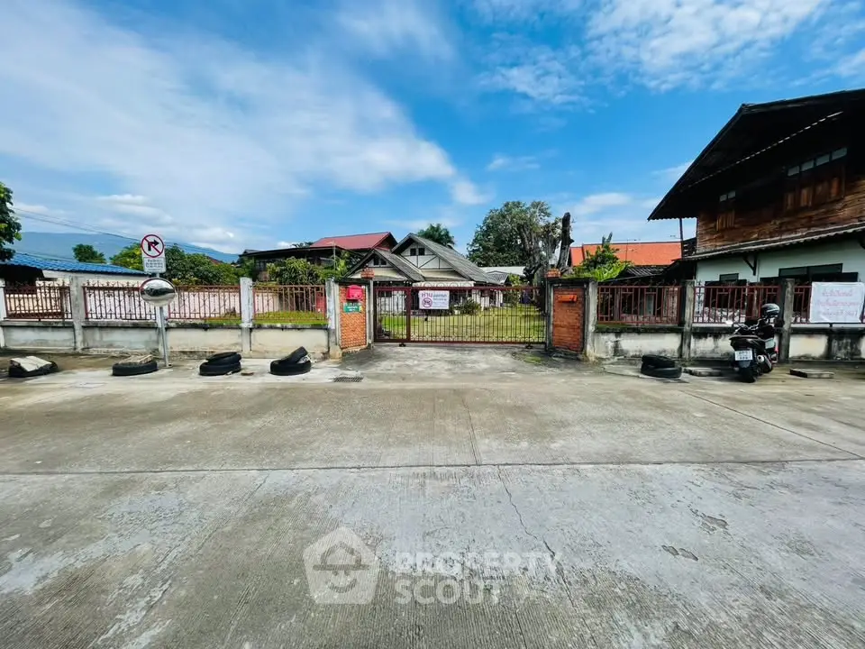 Charming rustic property with spacious yard and traditional architecture under a clear blue sky.