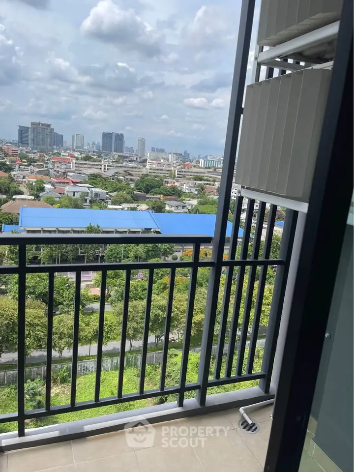 Stunning cityscape view from a modern balcony with sleek railing design.