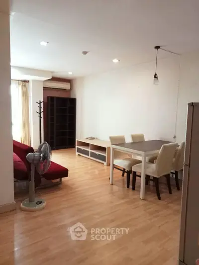 Spacious living room with dining area and modern furniture in a bright apartment