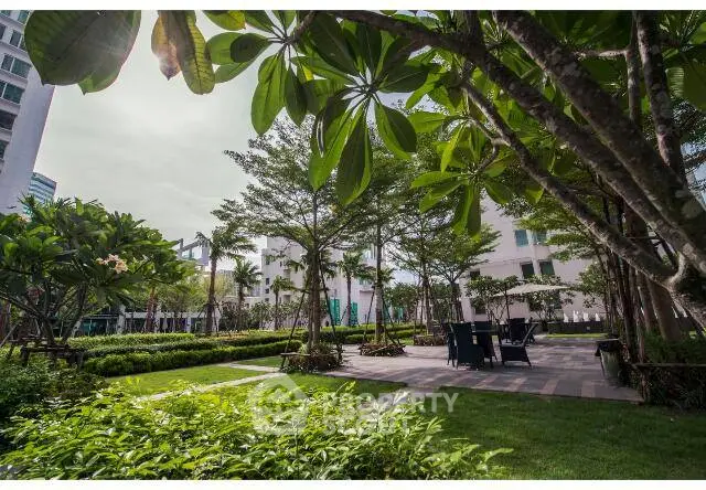 Lush garden area with seating in modern residential complex