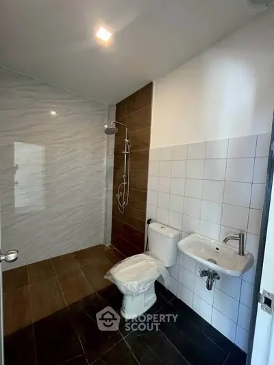 Modern bathroom with sleek shower and contemporary fixtures in a stylish real estate property.