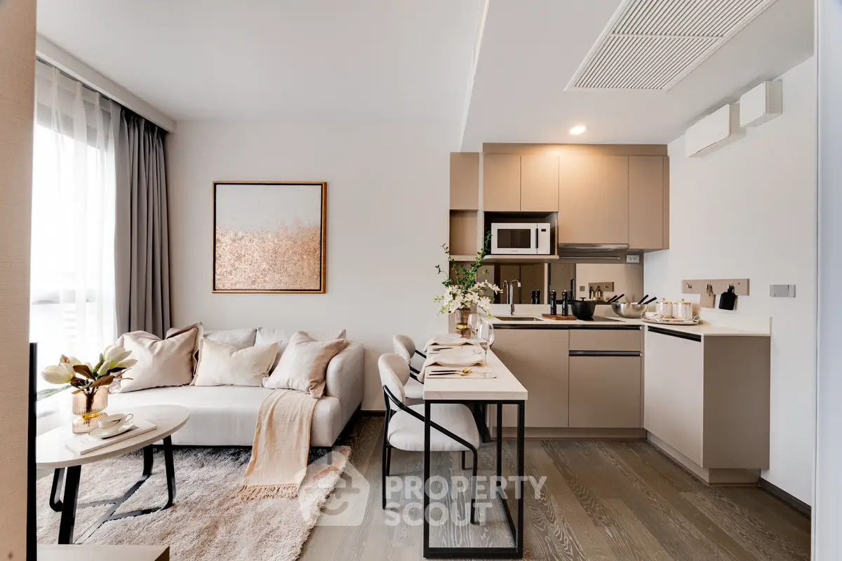 Modern open-plan living room and kitchen with stylish decor and natural light.
