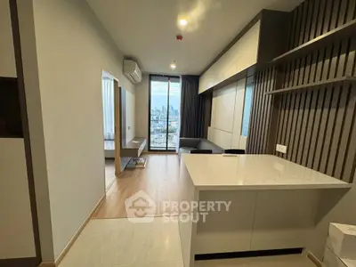 Modern apartment interior with open layout and city view from balcony.