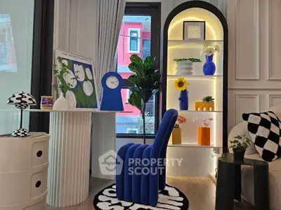 Stylish modern living room with unique blue chair and decorative shelving