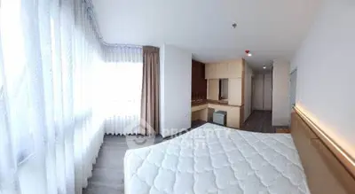 Spacious bedroom with large windows and modern decor