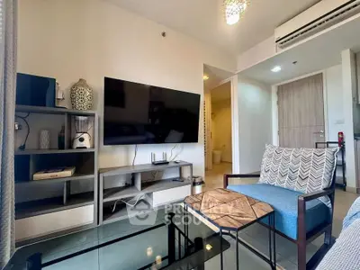 Modern living room with stylish decor and wall-mounted TV in a cozy apartment.