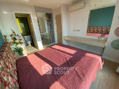 Charming bedroom with floral accents and natural light, featuring modern decor and cozy ambiance.