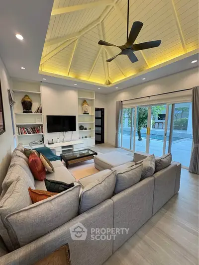 Spacious living room with vaulted ceiling and modern decor