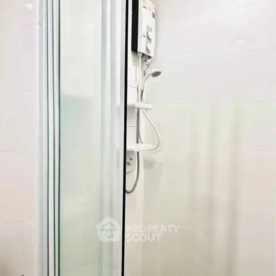 Modern bathroom with sleek shower enclosure and water heater