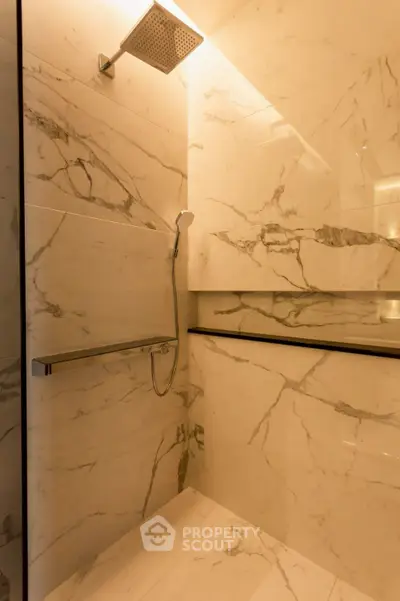 Luxurious marble bathroom shower with modern fixtures and elegant design.