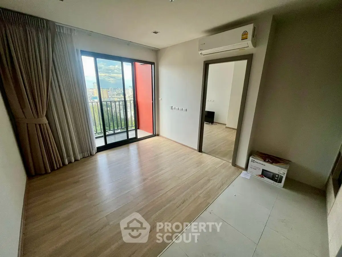 Spacious living room with balcony and city view in modern apartment