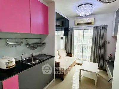 Chic modern living room with vibrant pink cabinets and elegant chandelier