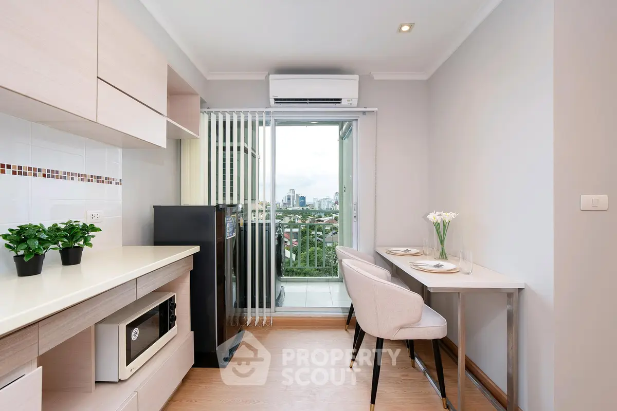 Modern kitchen with open layout and balcony view in a stylish apartment.